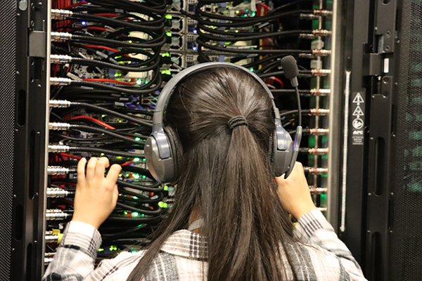 Student feeling the heat being transfered throughout a supercomputer cluster