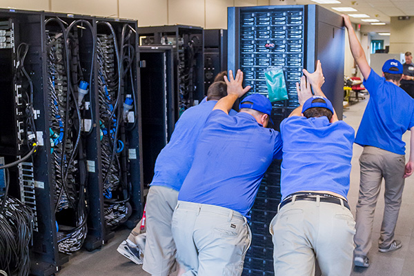 Group pushing supercomputer rack during 2016 Owens supercomputer build