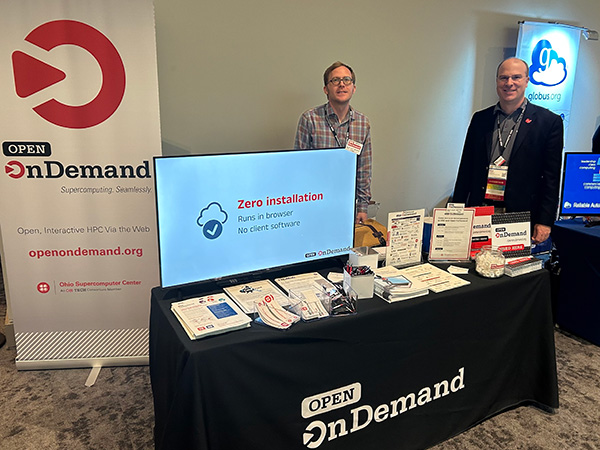 Jeffrey Ohrstrom and Alan Chalker staffing Open OnDemand table at PEARC23.