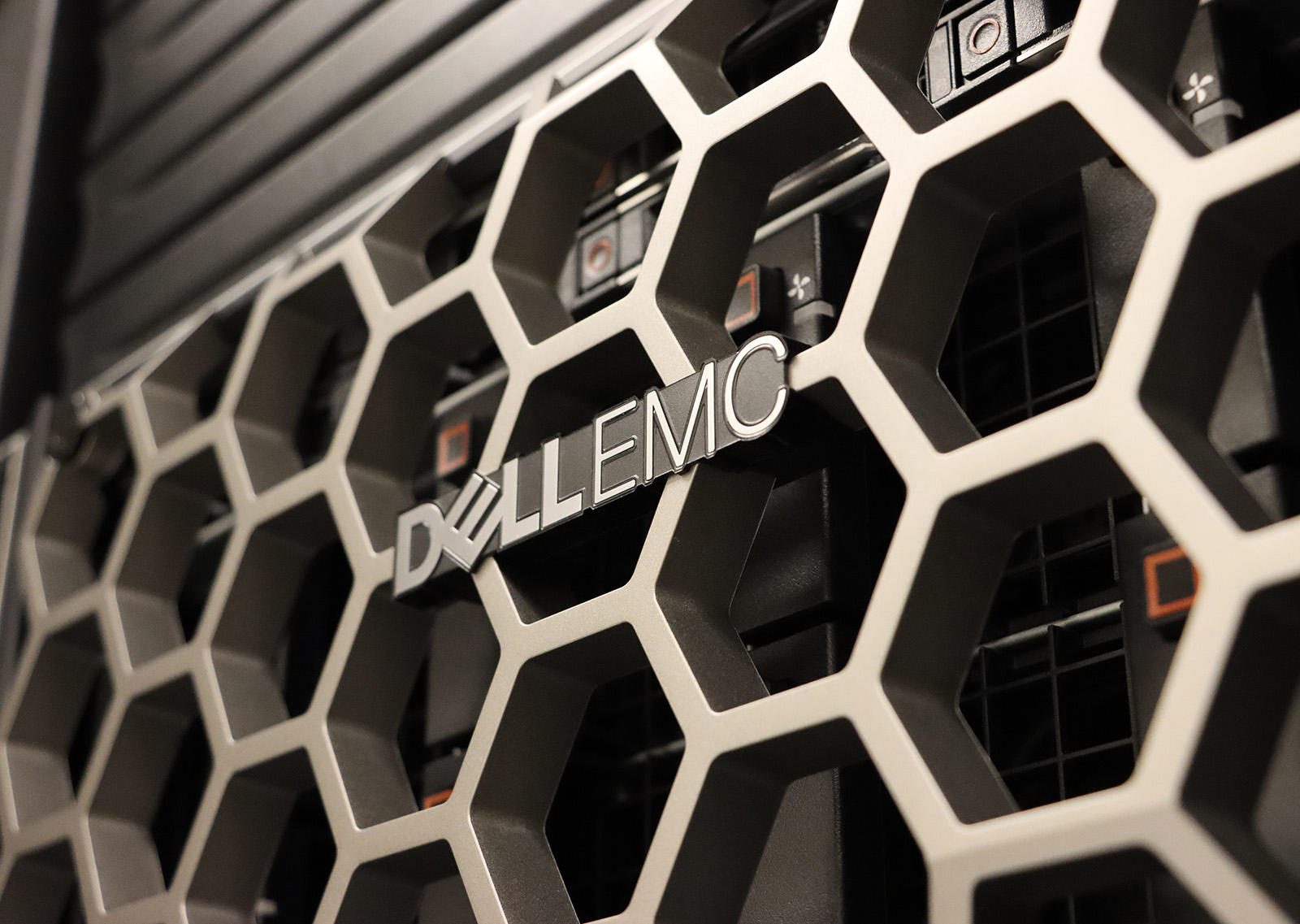 The faceplate of the Ascend test node, which reads 'Dell EMC' with a hexagonal pattern behind the text.