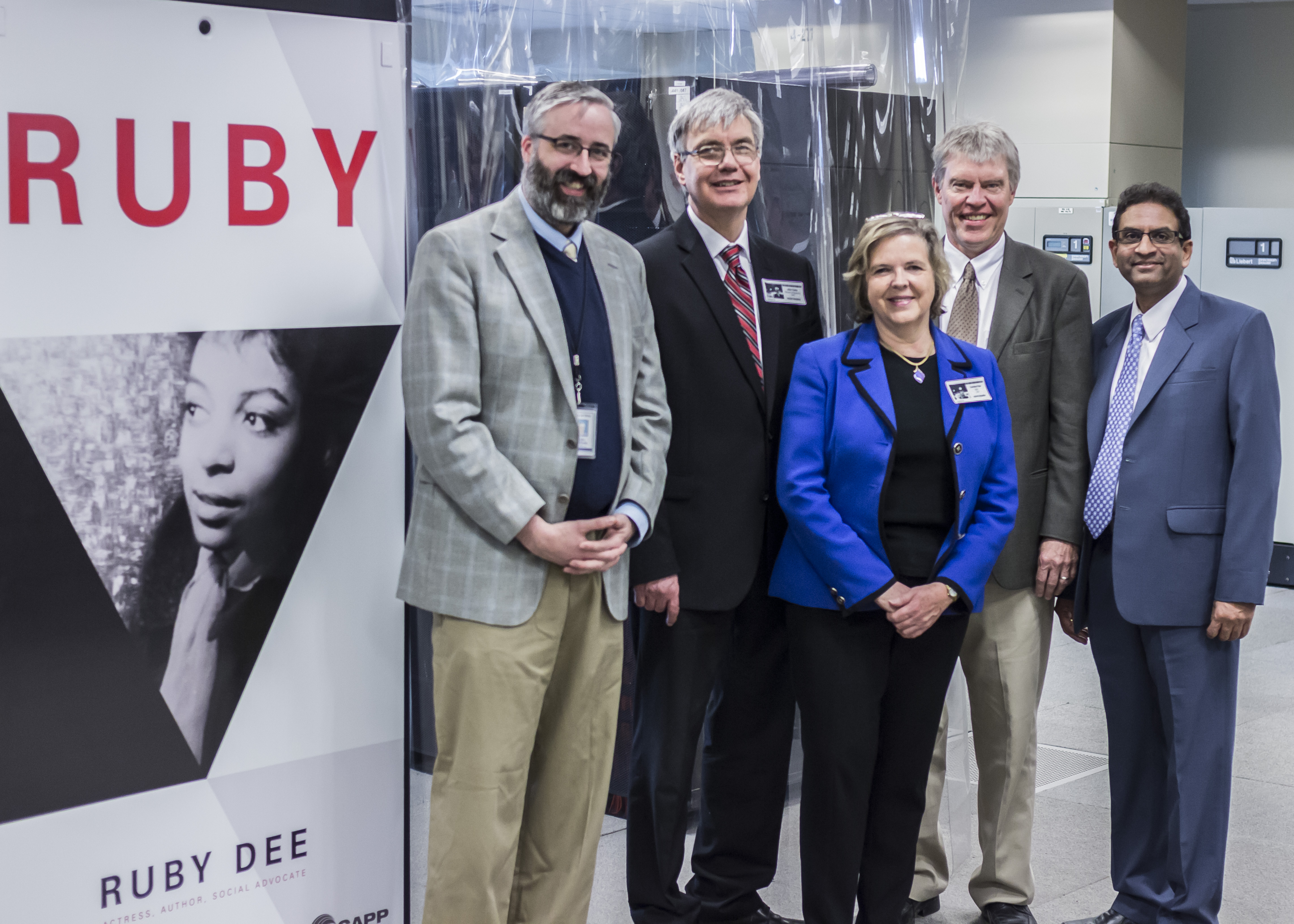 Officials pose with the freshly installed name plate for the Ruby Cluster