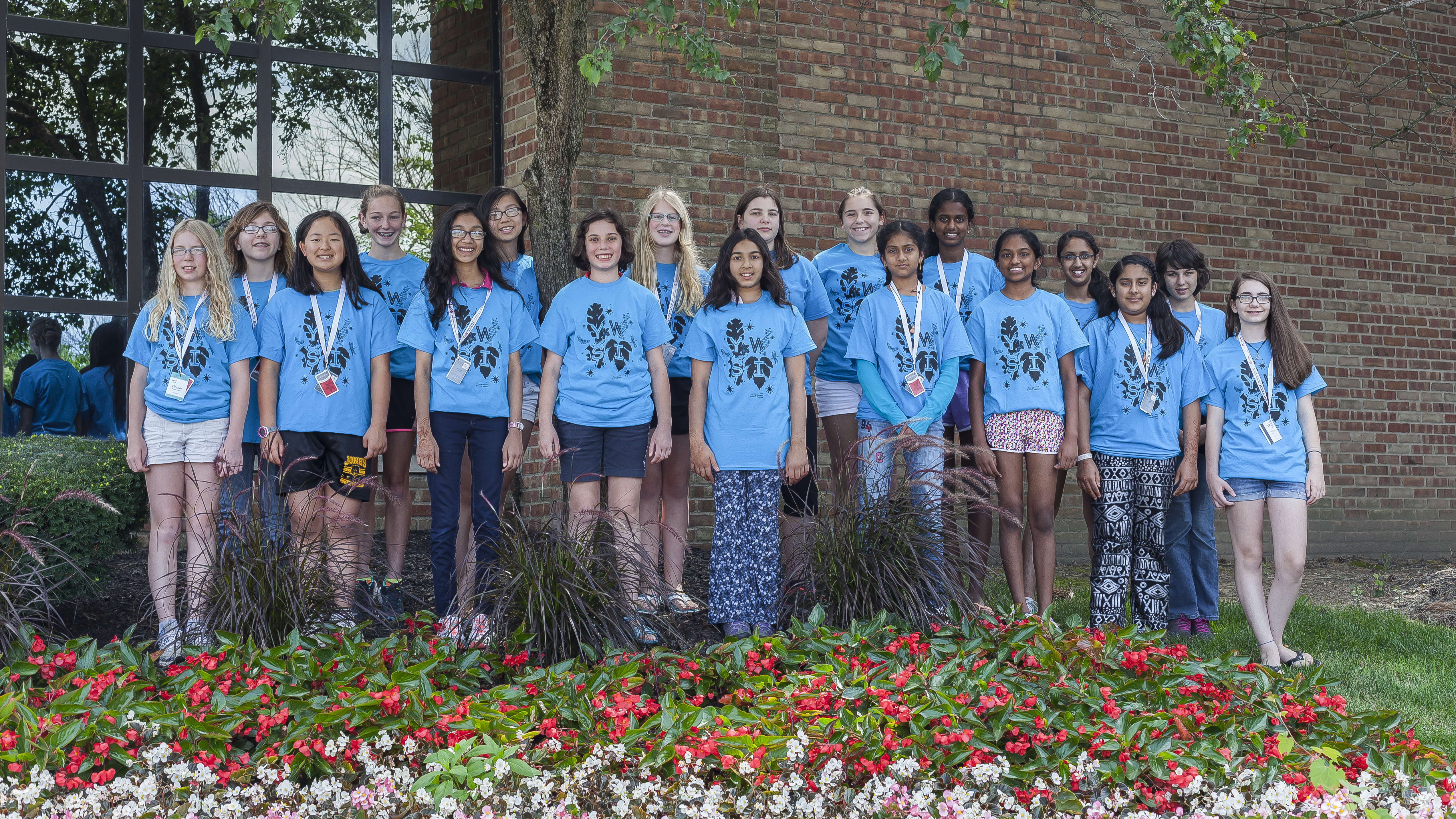 Past YWSI class standing at the entrance of OSC.